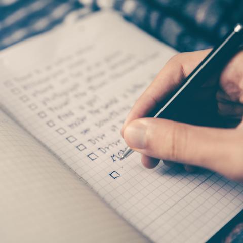 person writing daily task list