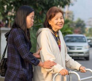 Caregiver helping a person cross the street